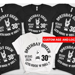 May include: Five black t-shirts with white text and graphics that say "Birthday Crew" and "Birthday Queen". The text includes "Vegas 2024" and "Lets Rock 'N' Roll!!" with a graphic of a hand making a rock and roll sign. The shirts are all size 30th.
