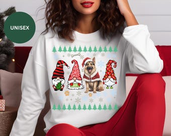 May include: White unisex sweatshirt with a Christmas design featuring a German Shepherd dog and three gnomes. The text on the sweatshirt reads "Merry Christmas".