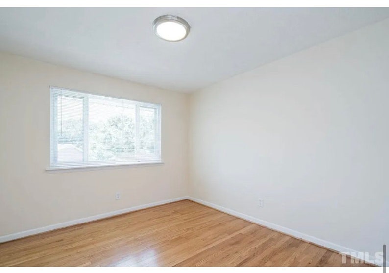 May include: A bright, empty room with hardwood floors and a single window with white blinds. The room has a white ceiling with a recessed light fixture.