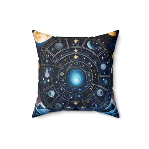 May include: A blue and gold throw pillow with a celestial design featuring a circle with stars, moons, and planets. The background is a dark blue with a hint of purple.