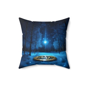 May include: A blue and white throw pillow with a snowy forest scene and a gold circular design in the foreground.