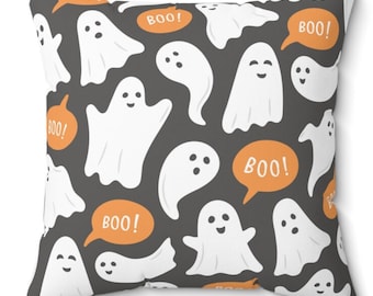 May include: A gray throw pillow with a white and orange pattern of ghosts and the word "BOO!" in a speech bubble.