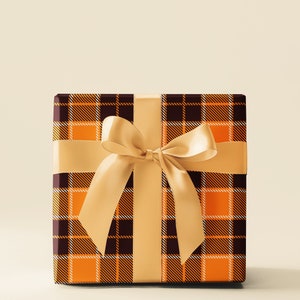 May include: A brown and orange plaid gift box with a gold satin ribbon tied in a bow.