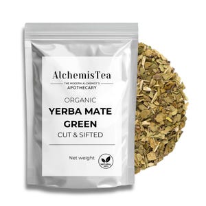 May include: A silver pouch with a white label that reads "AlchemisTea The Modern Alchemist's Apothecary Organic Yerba Mate Green Cut & Sifted Net weight NATURAL 100%". The pouch contains loose green yerba mate tea leaves.