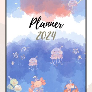 May include: A whimsical 2024 planner with a watercolor design. The cover features the word "Planner" and the year "2024". The background is a mix of blue, pink, and white hues, with illustrations of jellyfish, a turtle, an axolotl, and a crab, all wearing party hats.