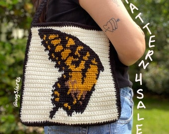 May include: A white crochet bag with a black border and a crocheted butterfly design in shades of yellow, orange, and brown. The bag has a black strap and the text "PATTERN 4 SALE" is written on the side.