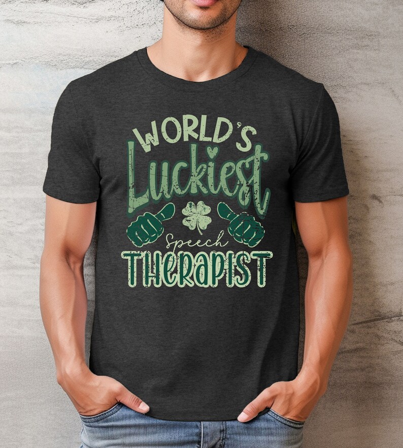 May include: Dark gray t-shirt with the text "WORLD'S Luckiest Speech Therapist" in green and white. The design includes a shamrock and thumbs-up graphics, perfect for speech therapists.