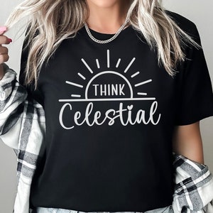 May include: Black t-shirt with a white graphic of a sun with the text "Think Celestial" underneath.