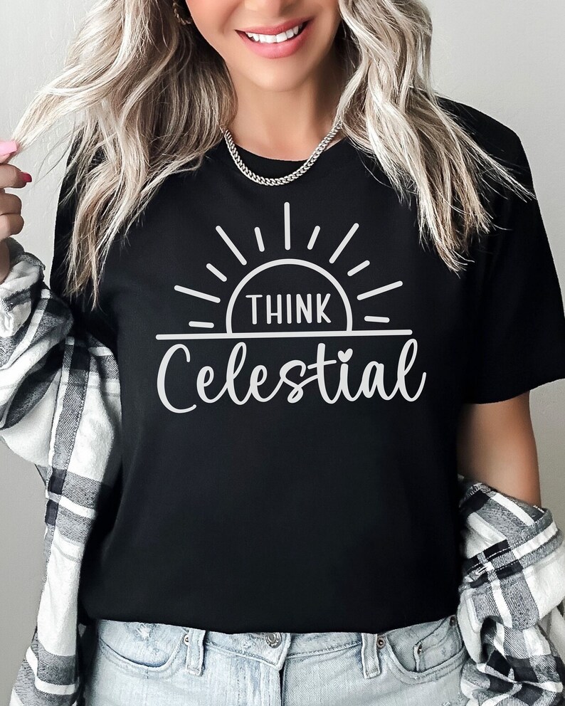 May include: Black t-shirt with a white graphic of a sun with the text "Think Celestial" underneath.