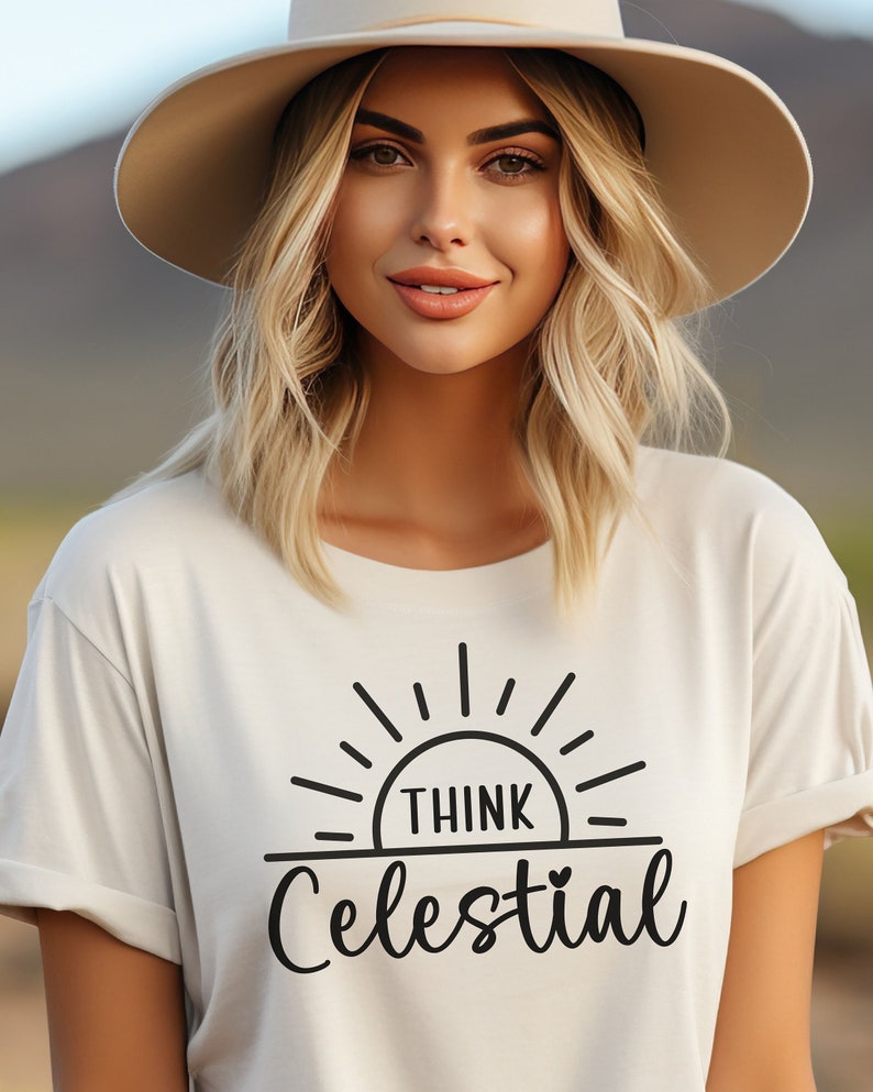 May include: A white t-shirt with a black graphic of a sun with the text "Think Celestial" underneath.
