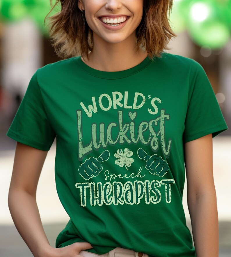 May include: A green t-shirt with the text "WORLD'S Luckiest Speech Therapist" in a distressed font. The design includes a four-leaf clover and thumbs-up symbols. The shirt is a solid green color.