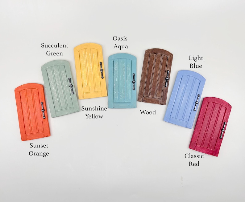 Pu&ograve; includere: Una collezione di porte delle fate in miniatura in vari colori, tra cui Arancione Tramonto, Verde Succulento, Giallo Sole, Aqua Oasis, Legno, Blu Chiaro e Rosso Classico. Ogni porta ha una maniglia decorativa ed &egrave; etichettata con il suo nome di colore.