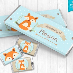 May include: Blue and brown printable chocolate bar wrappers with a fox illustration and the text "is turning 21! Mason".