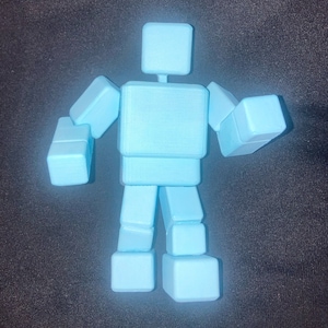 May include: A light blue articulated robot toy made of stacked cubes. The robot has a head, torso, arms, and legs.