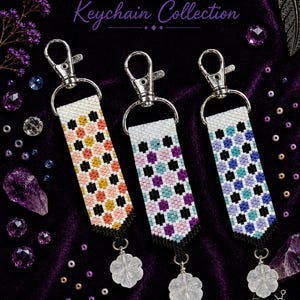 May include: Three beaded keychains featuring a geometric spot pattern in orange, pink, blue, and black on a white background. Each keychain has a silver lobster clasp and a clear flower-shaped charm. Text reads BEAD MEDICINE PEYOTE PATTERN SPOTS.