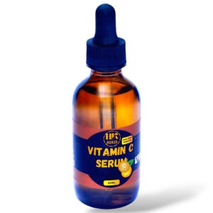 Op de afbeelding: Een bruine glazen fles met een zwarte druppelaar en een etiket met de tekst "1PC HUKED DARK SPOT REMOVER VITAMIN C SERUM 50ML". Het etiket heeft ook een kleine sinaasappel met een "C" erop.