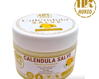 May include: A white jar with a yellow lid containing Calendula Salve. The jar is labeled with the brand name "HUKED" and the product name "Calendula Salve". The label also states that the product is natural and handmade, and lists its benefits, including anti-inflammatory, helps soothe rashes, eczema relief, and relieves sunburn. The jar is 4 fl oz (120 ml).
