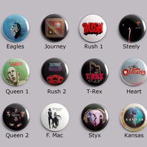 May include: A collection of twelve round pinback buttons featuring various rock band logos and album art. Bands include Eagles, Journey, Rush, Queen, T-Rex, Heart, and others. Each button has a unique design and color scheme, with text identifying the band.