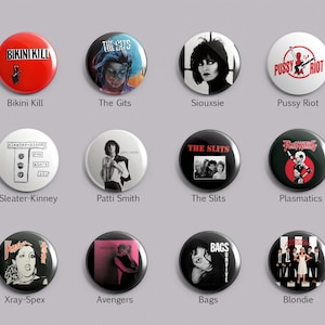 May include: A set of twelve circular pin-back buttons featuring various music band graphics and text including Bikini Kill, The Gits, Siouxsie, Pussy Riot, Sleater-Kinney, Patti Smith, The Slits, Plasmatics, Xray-Spex, Avengers, Bags, and Blondie.