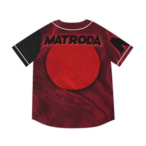 May include: Baseball jersey with a red and maroon marbled design, featuring a large red circle and the word "MATRODA" in orange. The sleeves are black with white trim.