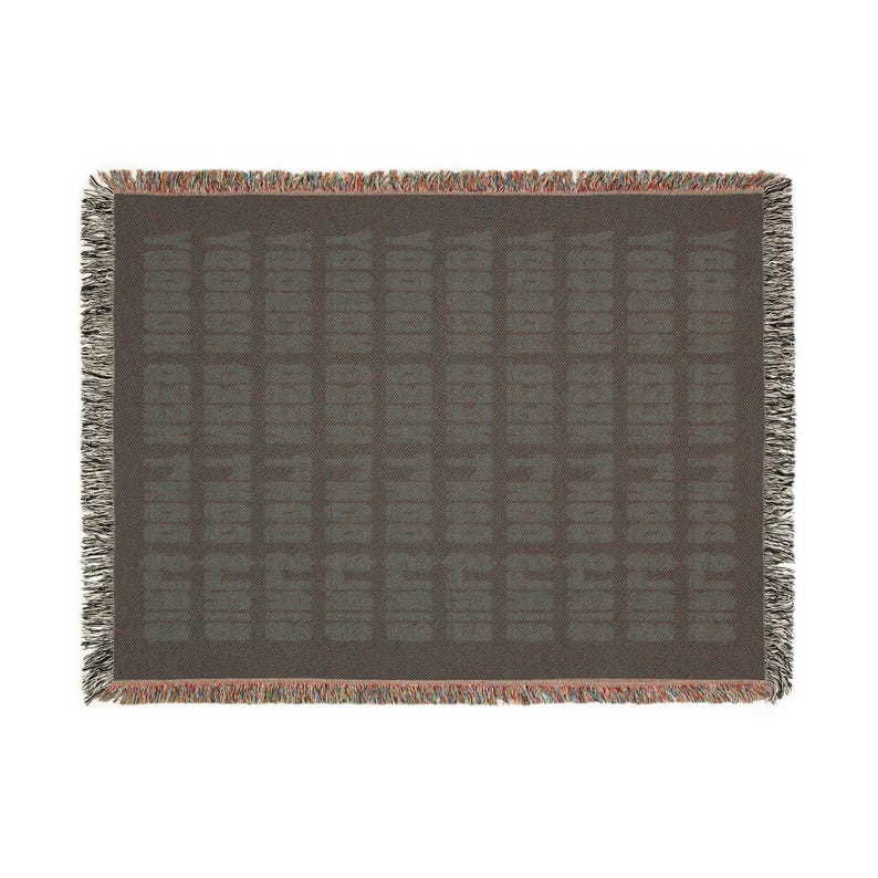 May include: A woven throw blanket with a dark gray background and a repeating pattern of the word "TODAY" in a lighter gray color.