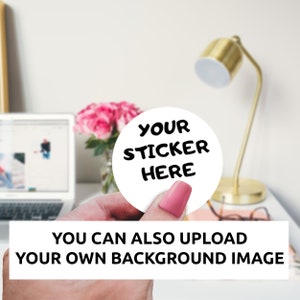 May include: A white round sticker with black text that says "YOUR STICKER HERE". The sticker is being held by a hand against a white background.