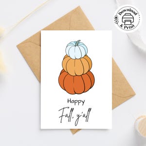 May include: A printable greeting card with a stack of three pumpkins. The pumpkins are orange, yellow, and white. The text on the card reads "Happy Fall, y'all".
