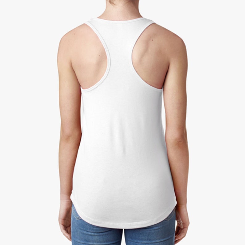 May include: White racerback tank top with a scoop neck. The tank top is made of a soft, comfortable fabric and has a relaxed fit.