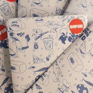 May include: A stack of white envelopes with a blue and white pattern. The pattern includes a variety of cartoon characters and objects, including a dog, a plant, a drink, and a hat. The envelopes have red stickers with the word "OOPSIE" on them.