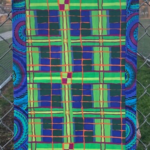 May include: A blue and green plaid fabric with a swirling blue and purple border. The fabric is made of a soft, lightweight material and is perfect for quilting, sewing, or crafting.