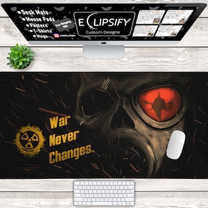 Könnte beinhalten: Eine schwarze und graue Gasmaske mit einem roten Auge und einem Totenkopfdesign. Der Text "War Never Changes." ist in Gelb auf schwarzem Hintergrund geschrieben. Das Bild ist ein Design für eine Mausmatte.
