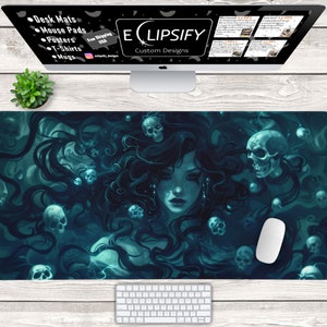 May include: A dark blue and teal desk mat with a woman's face surrounded by skulls. The woman has long black hair and is wearing a necklace. The background is a dark blue and teal color. The desk mat is a great way to add a touch of personality to your workspace.