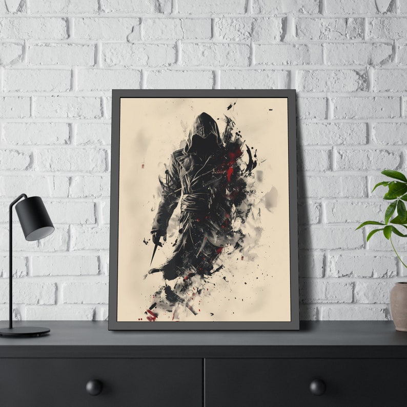 May include: Framed art print featuring a hooded figure in a black coat, holding a knife. The artwork uses a blend of black, red, and white brushstrokes against a beige background. The print is displayed in a black frame, suitable for wall decor.