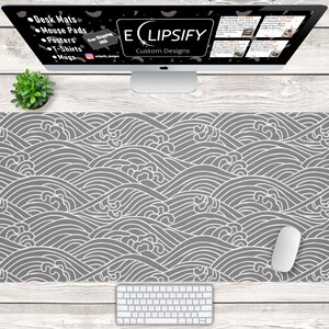 May include: A gray and white desk mat with a wave pattern. The mat is on a wooden surface with a white keyboard and a white mouse. The text "ECLIPSIFY Custom Designs" is visible on a computer screen in the background.