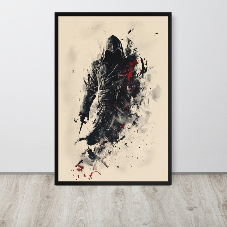 May include: Framed art print featuring a stylized illustration of a figure in a hooded cloak, holding a blade. The artwork uses a black, white, and red color palette with a splash effect, creating a dramatic and dynamic visual. The print is in a black frame.
