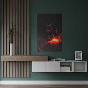 May include: A dark, moody illustration of a person sitting by a campfire in the woods. The fire is bright orange and red, and the person is silhouetted against the flames. The image is printed on a canvas and framed in a black frame.