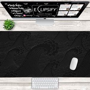 May include: Black and white desk mat with a wave pattern. The mat is on a wooden desk with a computer monitor, keyboard, and mouse. The monitor has a website for a company called "Eclipsify Custom Designs" with a list of products they sell, including desk mats, mouse pads, posters, t-shirts, and mugs.