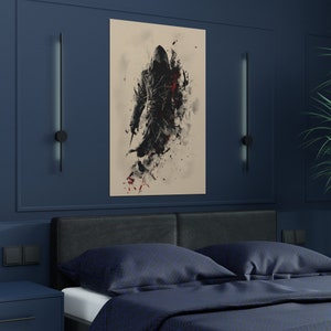 May include: A framed art print featuring a hooded figure in black and red, holding a blade. The artwork has a watercolor-like effect with splatters of red and black against a beige background. The print is displayed on a dark blue wall above a bed with navy blue bedding.