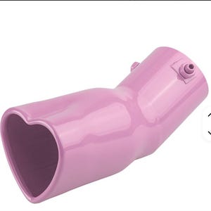 May include: A pink car exhaust tip with a heart-shaped opening. The exhaust tip is angled and has a smooth, glossy finish. It features a small fitting on the side and is designed to enhance the vehicle's appearance.