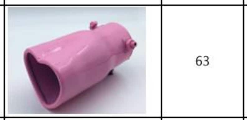 May include: A pink car exhaust tip with a heart-shaped opening. The exhaust tip has a smooth, glossy finish and small protruding details. The product is designed to be installed on a vehicle's exhaust system.
