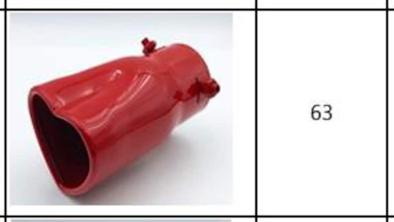 May include: A red, heart-shaped exhaust tip with a glossy finish. The exhaust tip has two small mounting studs and is angled slightly to the left. The product is shown against a white background.