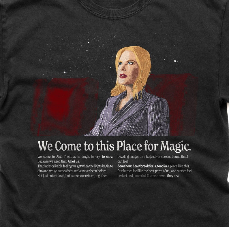 May include: A black t-shirt featuring a quote about the magic of going to the cinema. The quote reads "We Come to this Place for Magic." and is accompanied by a picture of a woman looking up at a starry sky.