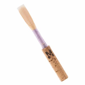 May include: A woodwind instrument reed featuring a light beige cane tip, a lavender thread wrapping, and a cylindrical cork base. The cork section is marked with a black letter M. The reed is constructed with a thin, tapered blade and a sturdy cork.