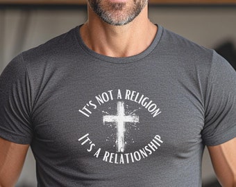 May include: Dark gray crew neck t-shirt with the text "It's not a religion, it's a relationship" surrounding a white cross graphic. The shirt is made of a soft, breathable material.