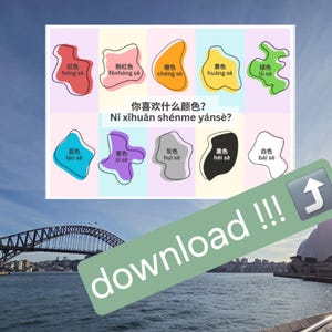 May include: A rectangular educational chart featuring ten irregular shapes in red, pink, orange, yellow, green, blue, purple, grey, black, and white. Each shape includes Chinese characters and pinyin text. The central text reads: 你喜欢什么颜色? Nǐ xǐhuān shénme yánsè?