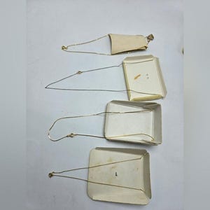 May include: Four gold chains on white cardboard backing. The chains are different lengths and are displayed in a vertical stack.