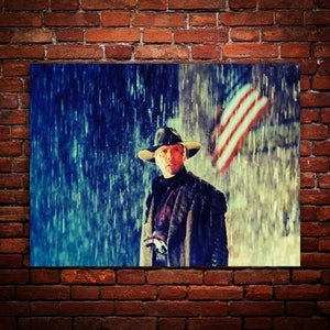 May include: A painting of a man wearing a cowboy hat and coat standing in the rain with an American flag in the background.
