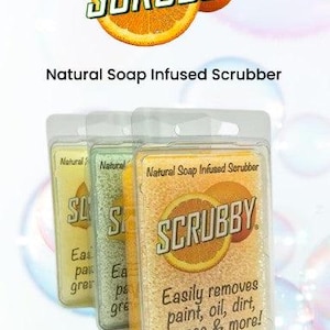 May include: Three natural soap infused scrubbers in clear plastic packaging. The scrubbers are labeled "Scrubby" and feature a citrus fruit design. The scrubbers are available in lemon, lemon lime, and orange scents.