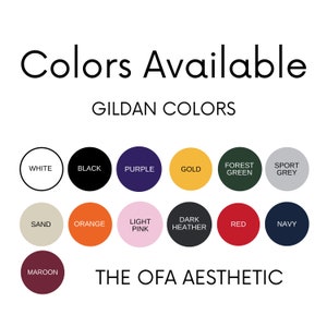 May include: A colour chart showing the available colours for Gildan apparel. The colours include white, black, purple, gold, forest green, sport grey, sand, orange, light pink, dark heather, red, navy, and maroon. The chart also includes the text "The OFA Aesthetic".