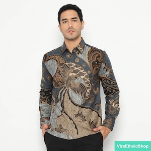 May include: A long-sleeved shirt with a blue background and a brown and gold batik pattern featuring a phoenix design.